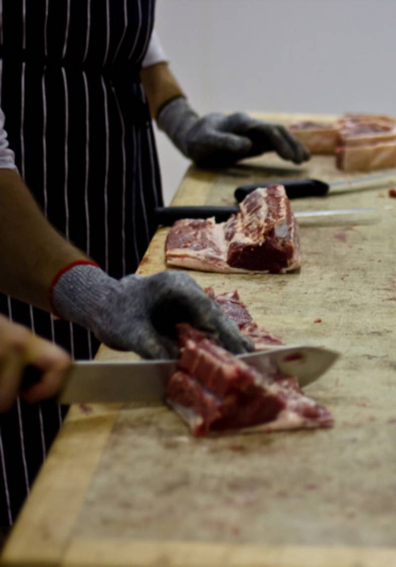 butcher cutting meat butcher cutting meat